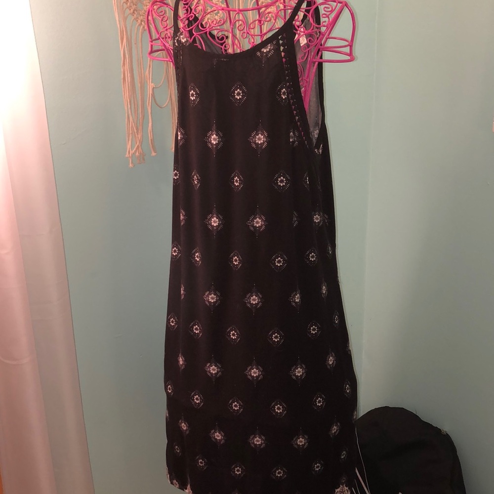 Black sun dress with white designs on it